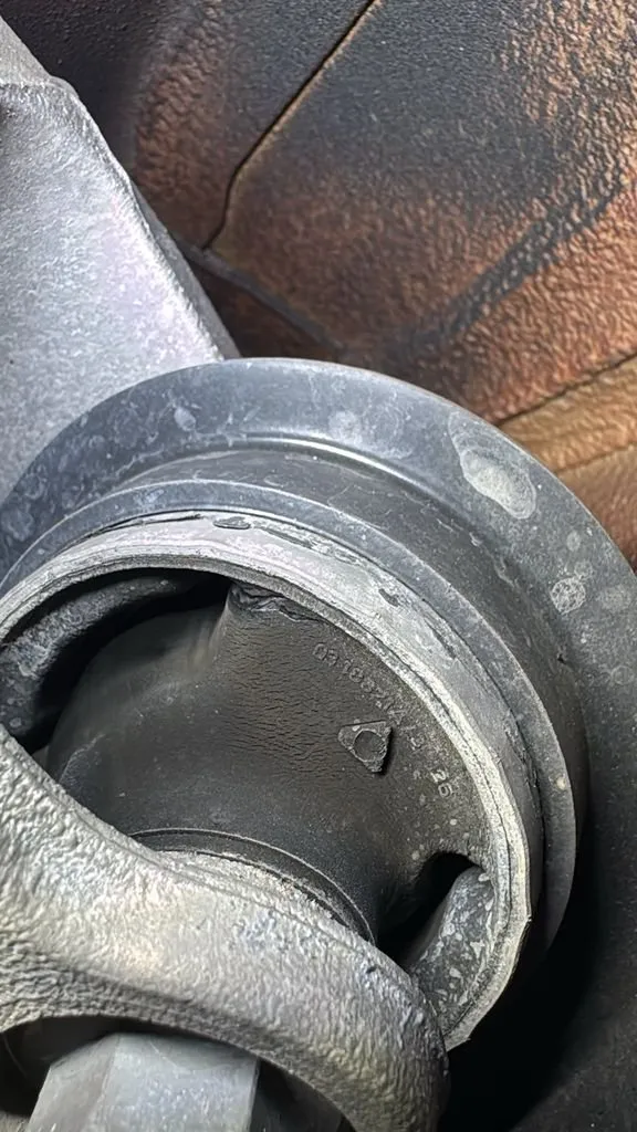 Worn cracked rubber bushing from Audi A3 suspension, showing deterioration requiring replacement