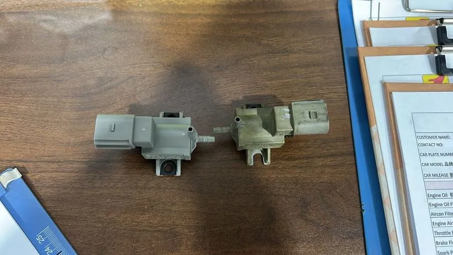 Old and new Audi A7 intake manifold solenoid valves laid side by side: the old unit is grimy and discoloured, the new unit is clean