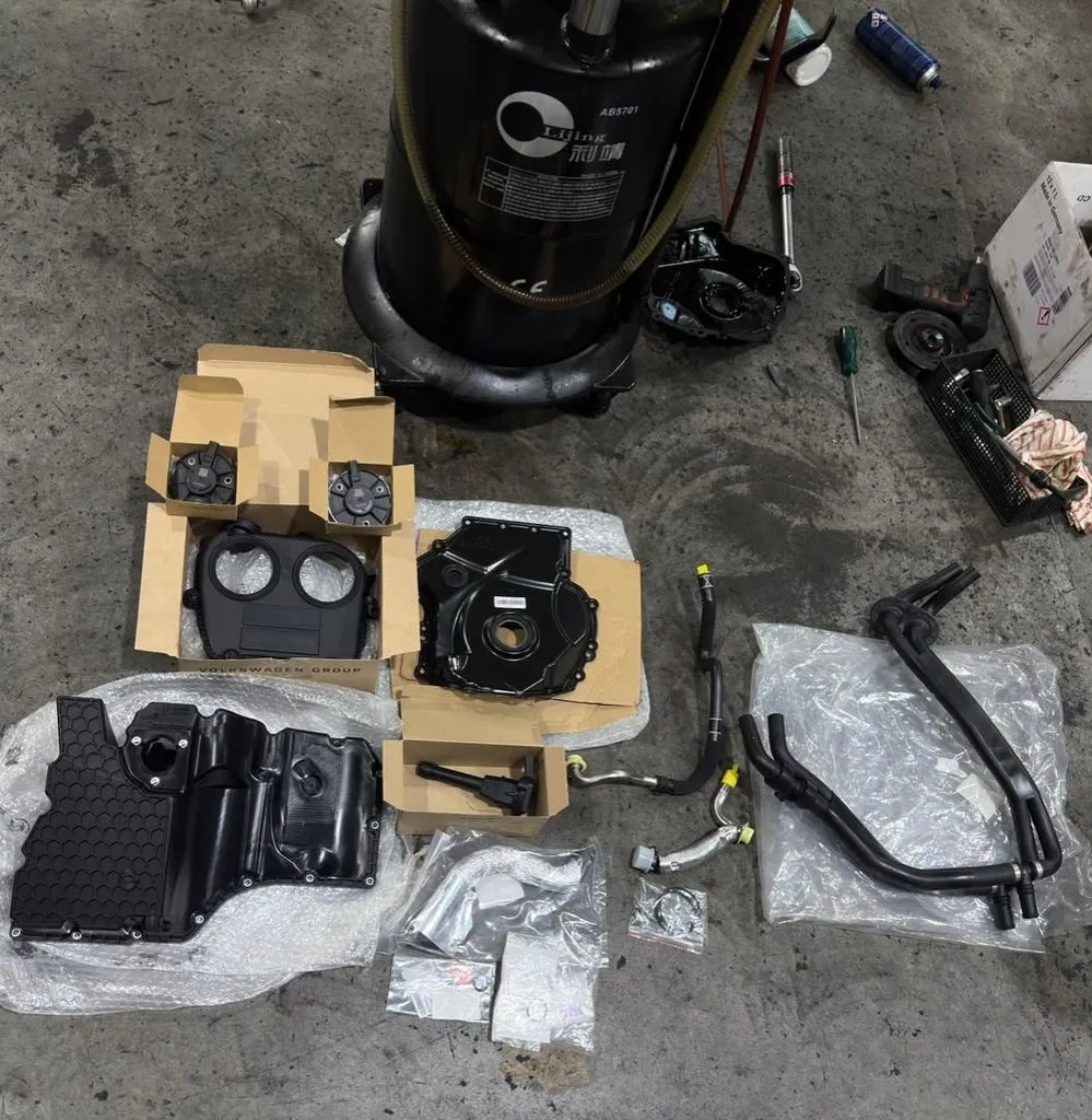 Oil leak repair parts for the Audi Q7 TFSI including timing cover gasket, oil separator and coolant hoses laid out at our Singapore workshop