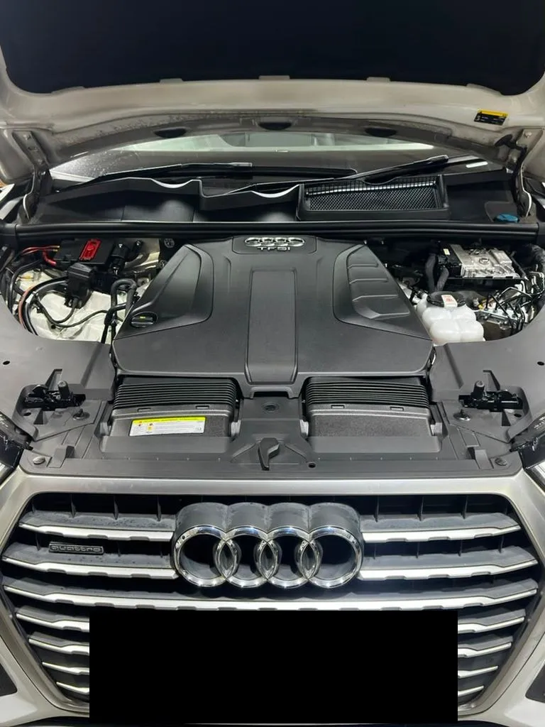 White Audi Q7 TFSI Quattro with the bonnet open at our Singapore workshop, showing the TFSI engine cover