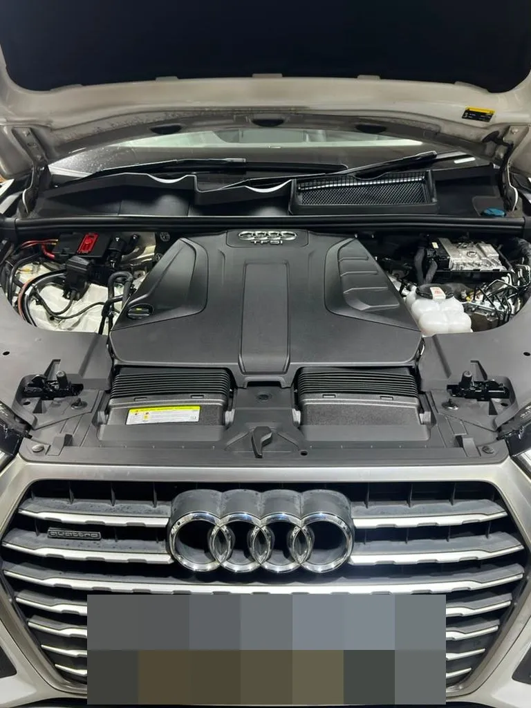 White Audi Q7 TFSI Quattro with the bonnet open at our Singapore workshop, showing the TFSI engine cover