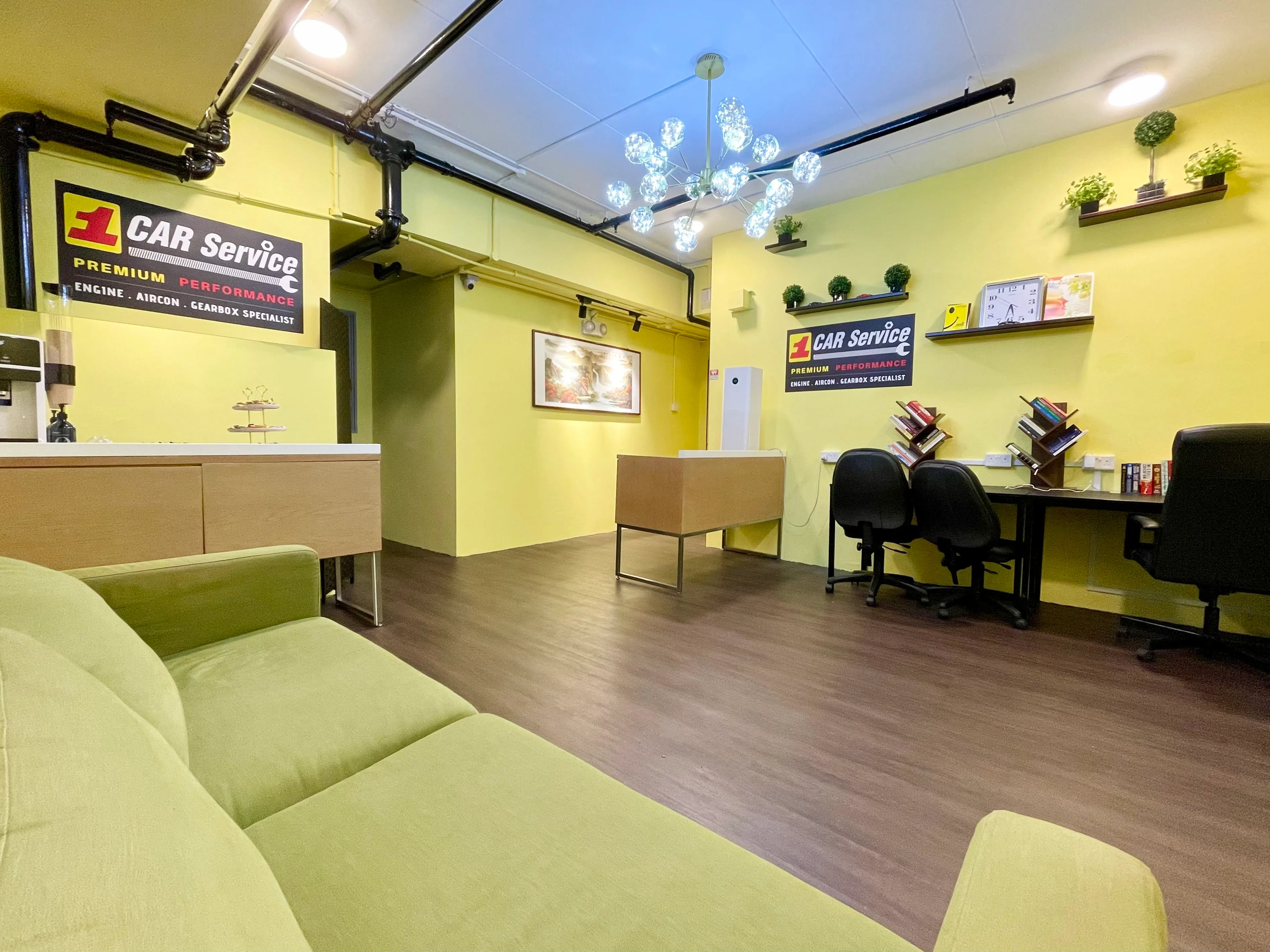 The customer lounge at our Sin Ming car workshop, with a work desk and sofa