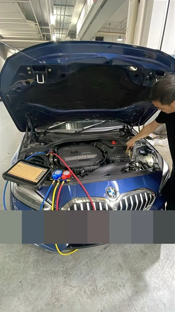 BMW 116i at 1 Car Service Workshop with bonnet open and aircon pressure gauges connected during aircon diagnosis