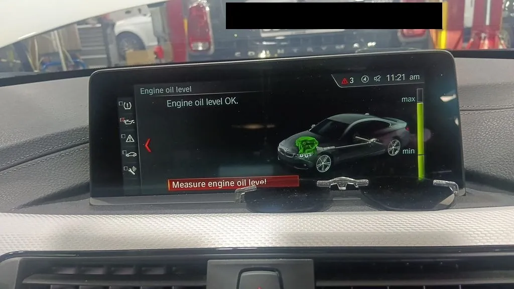 BMW 4 Series Coupe iDrive screen showing engine oil level check at our Singapore workshop