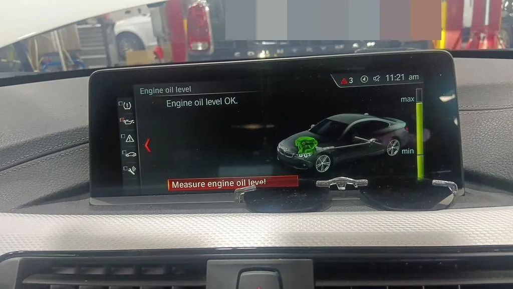 BMW 4 Series Coupe iDrive screen showing engine oil level check at our Singapore workshop