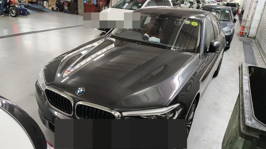 Dark grey BMW 5 Series G30 in our Singapore workshop, in for spark plug, ignition coil and valve cover replacement