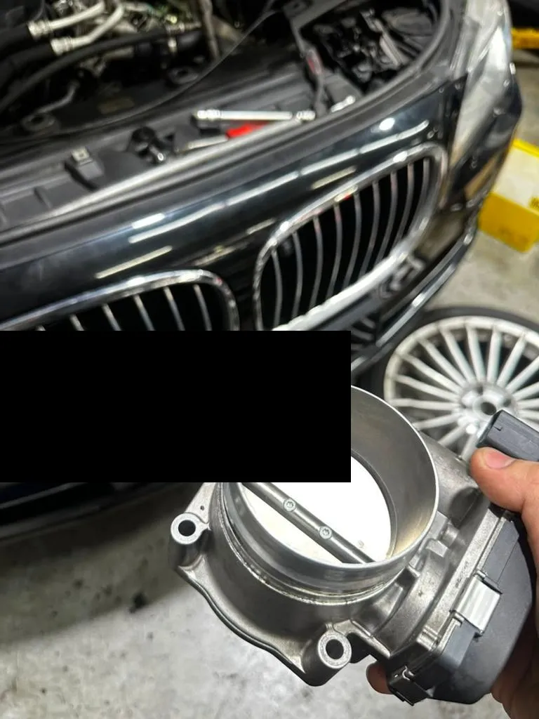 Throttle body removed for cleaning during a BMW 740Li major service at our Singapore workshop