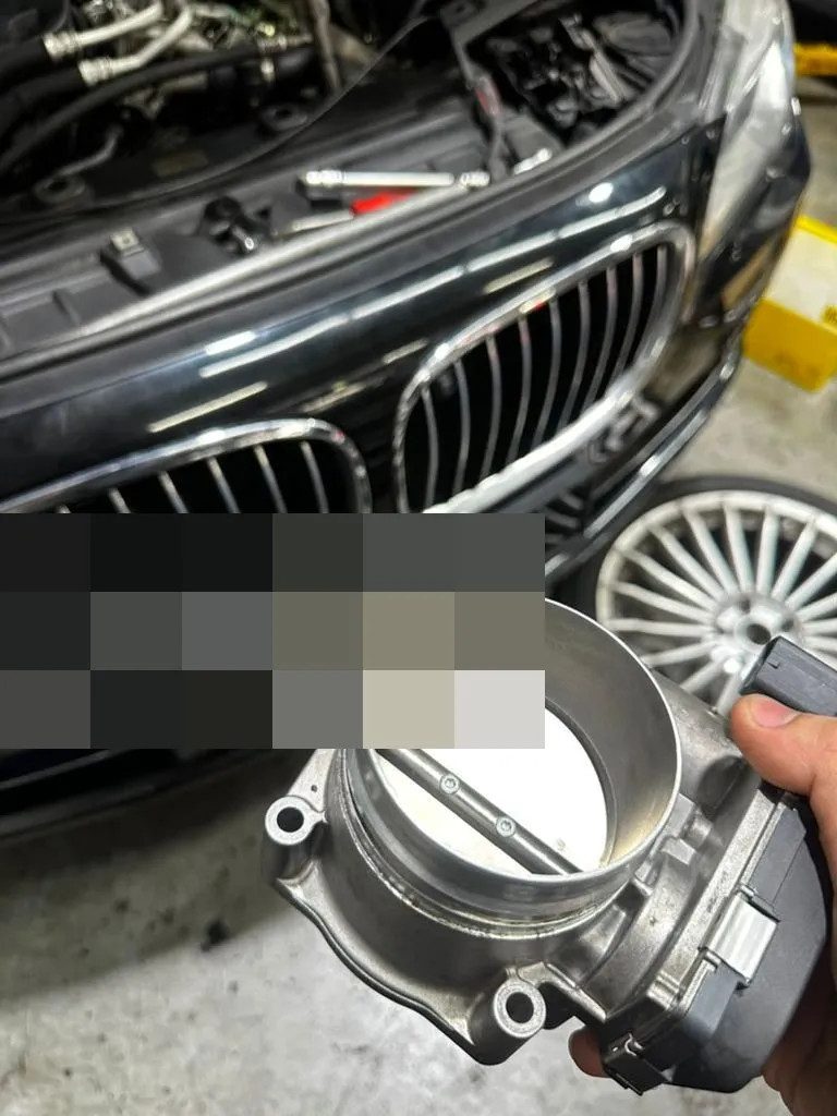 Throttle body removed for cleaning during a BMW 740Li major service at our Singapore workshop