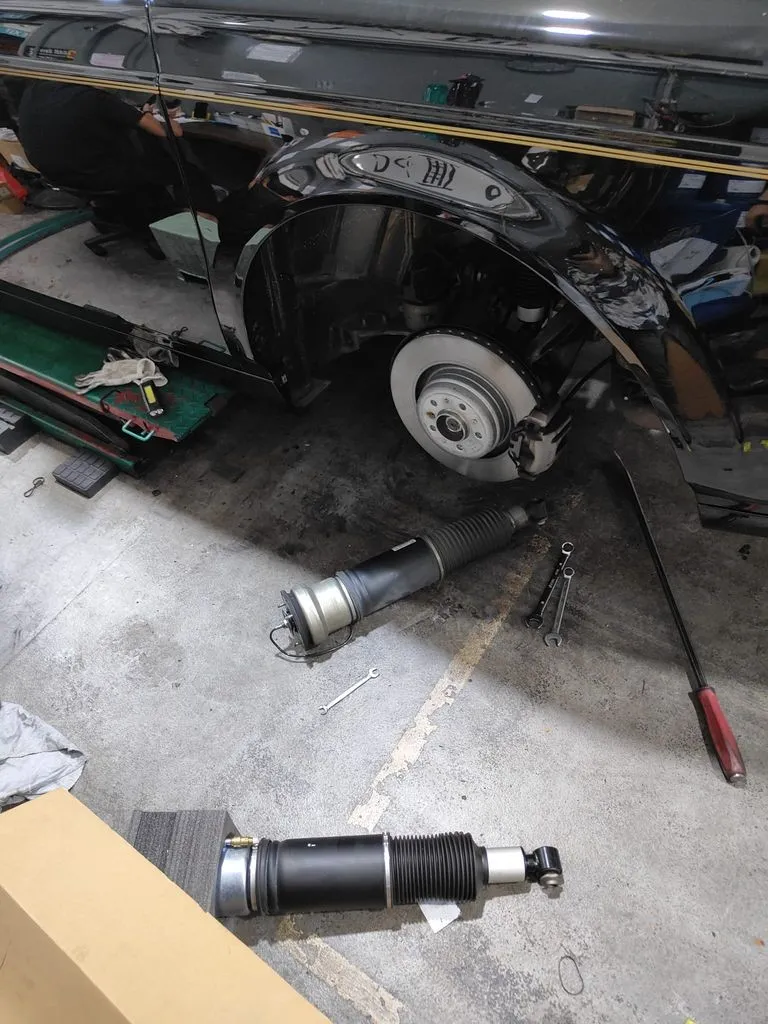 BMW Alpina B7 front corner with air suspension strut removed during replacement at our Sin Ming workshop