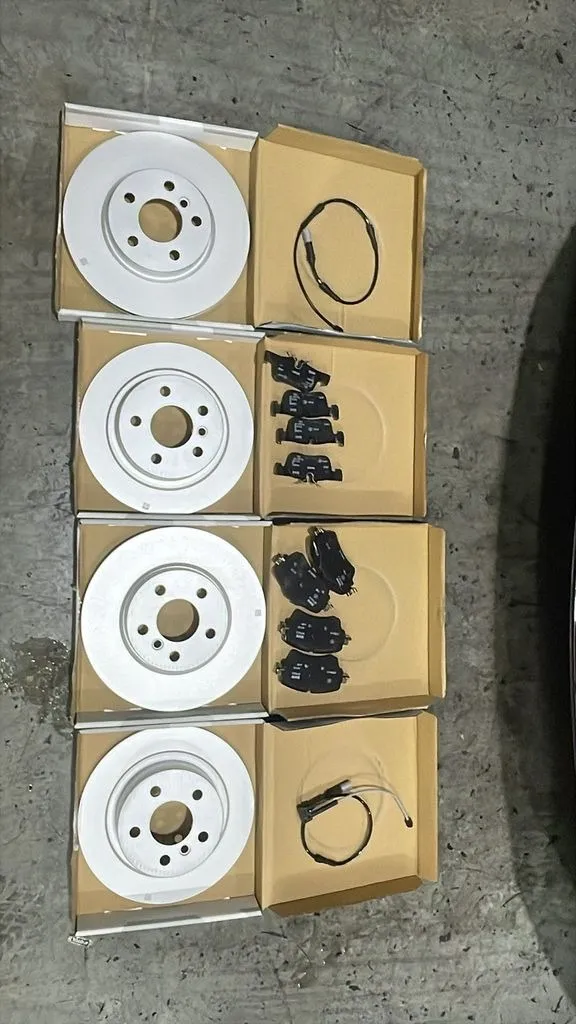 The new brake discs, pads and wear sensors for this BMW's front and rear axles, laid out at our Singapore workshop
