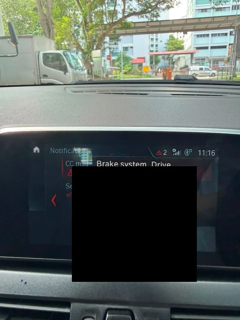 BMW iDrive screen showing brake system warning and rear brake pads alert before repair