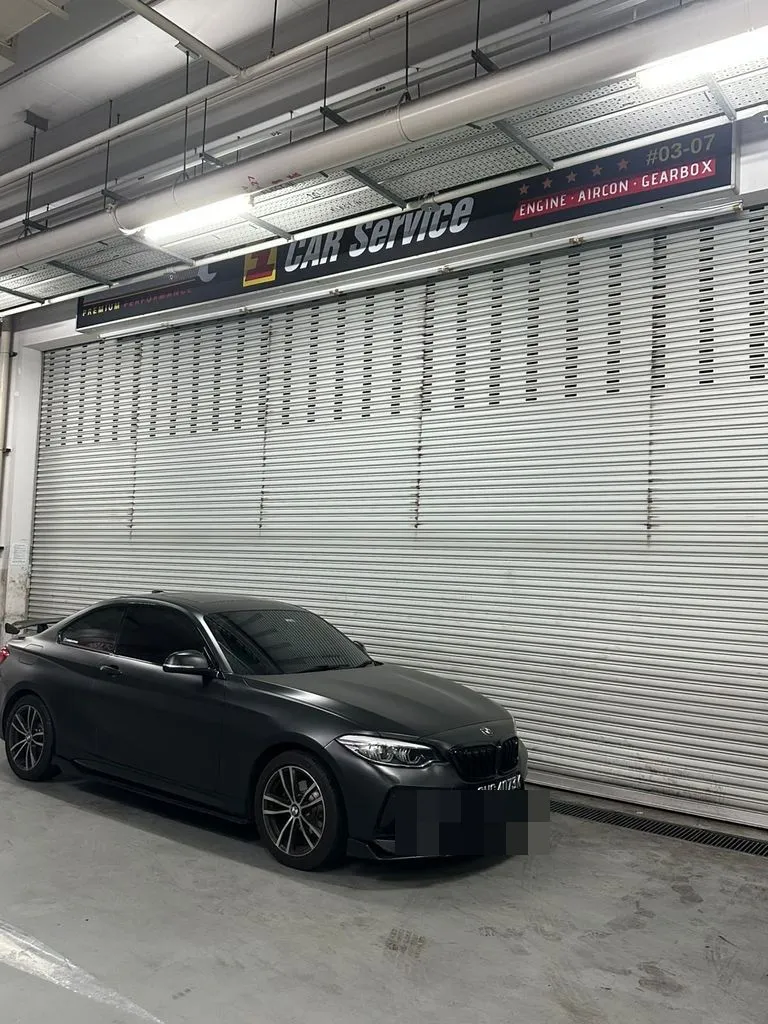 Matte black BMW M2 parked outside our Singapore workshop before gearbox overhaul
