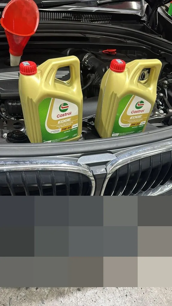 Castrol Edge 5W-40 engine oil ready in the engine bay of a BMW X1 during a service at our Singapore workshop