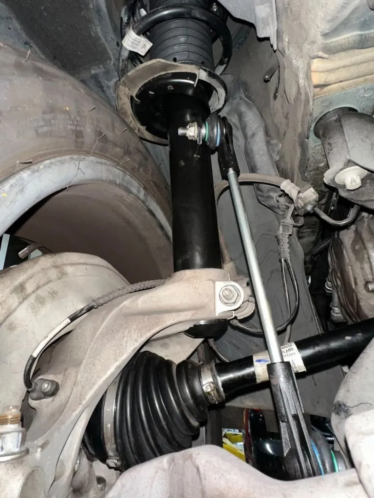 New front shock absorber fitted to the BMW X1 after replacing the worn unit