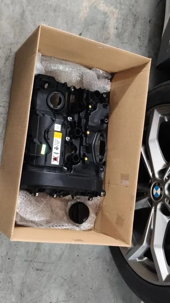 New BMW valve cover part laid out before fitting during the BMW X1 workshop visit at 1 Car Service Singapore