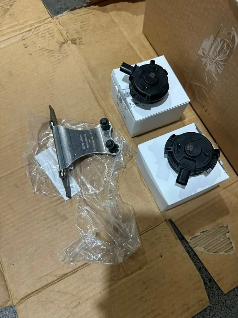 New BMW cam position magnets and replacement parts laid out before installation during valve cover and timing job