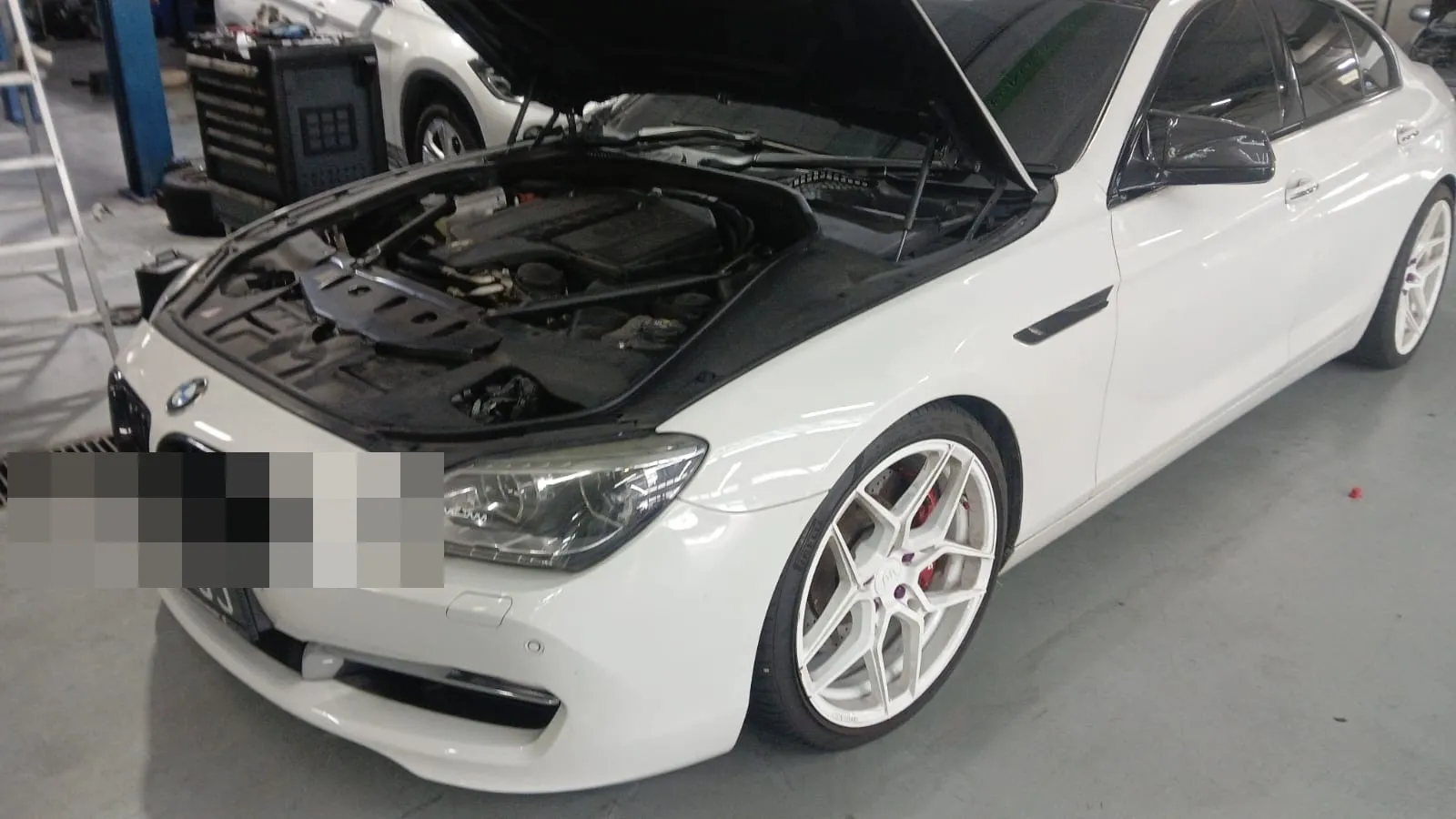 Engine bay open on a continental car in our Singapore workshop bay