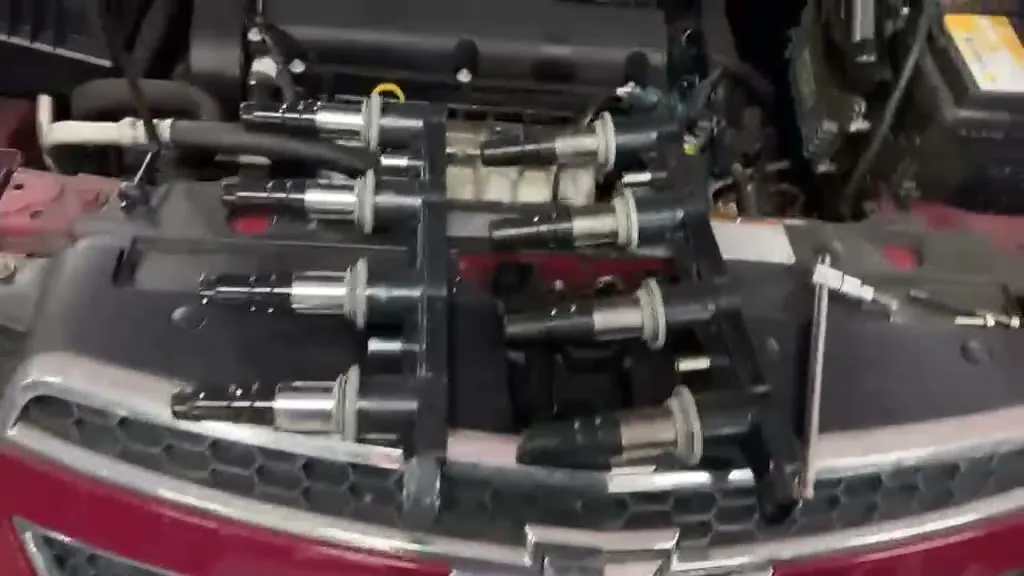 Ignition coils being removed from a Chevrolet Cruze engine during a misfire repair