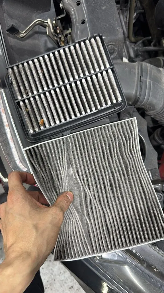 Old and new engine air and cabin filters laid out during Honda service at 1 Car Service Singapore