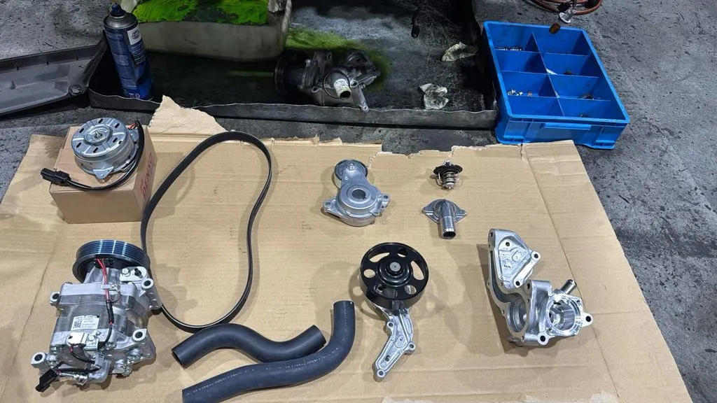 New aircon parts laid out for Honda Fit aircon repair at 1 Car Service Workshop in Singapore