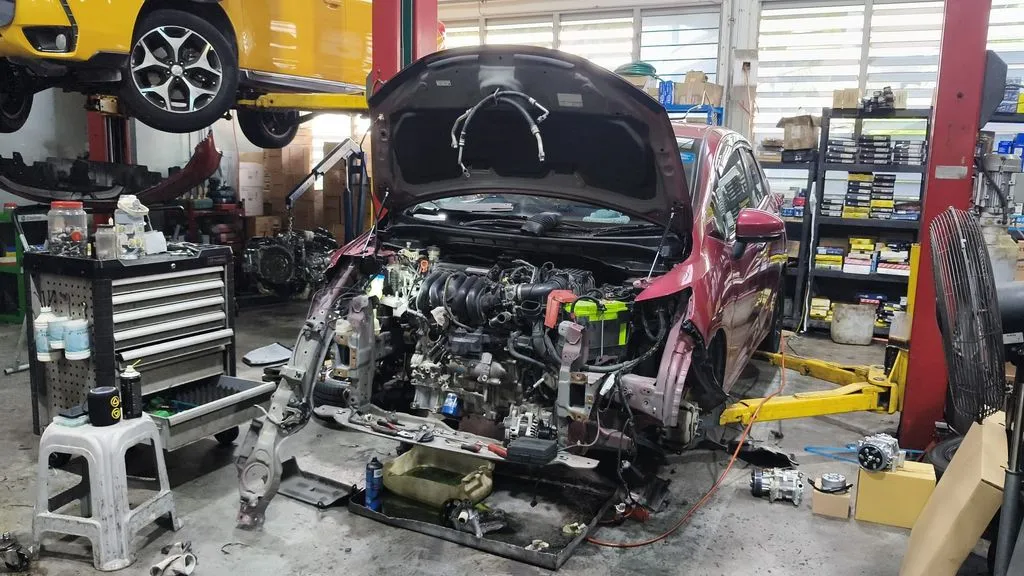 Honda Fit engine bay with aircon components removed during diagnosis at 1 Car Service Workshop
