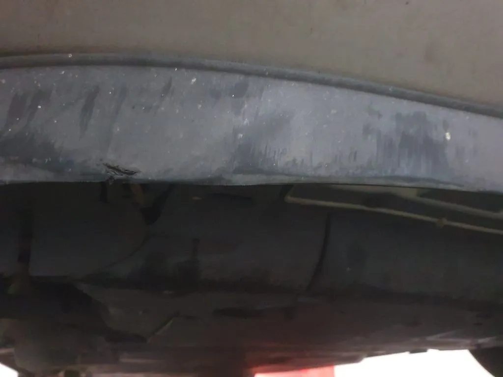 Underbody splash guard inspected and re-secured on a Honda Freed