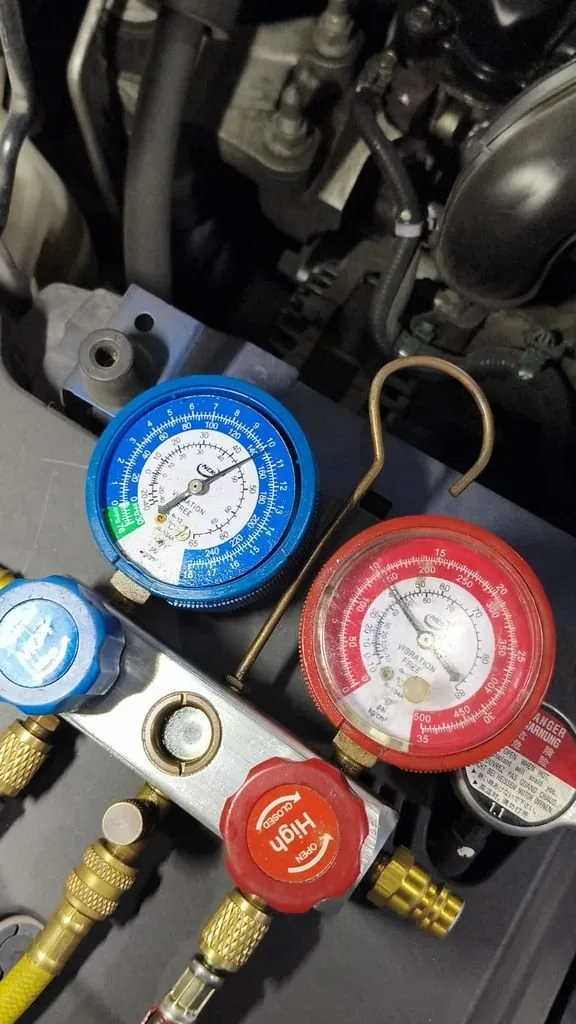 Manifold pressure gauge set connected to Honda HR-V aircon system showing high compressor pressure reading during diagnosis