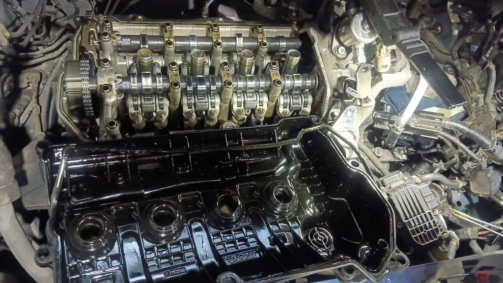 Honda HR-V VTEC engine with valve cover removed showing camshaft assembly during oil leak repair at 1 Car Service Singapore