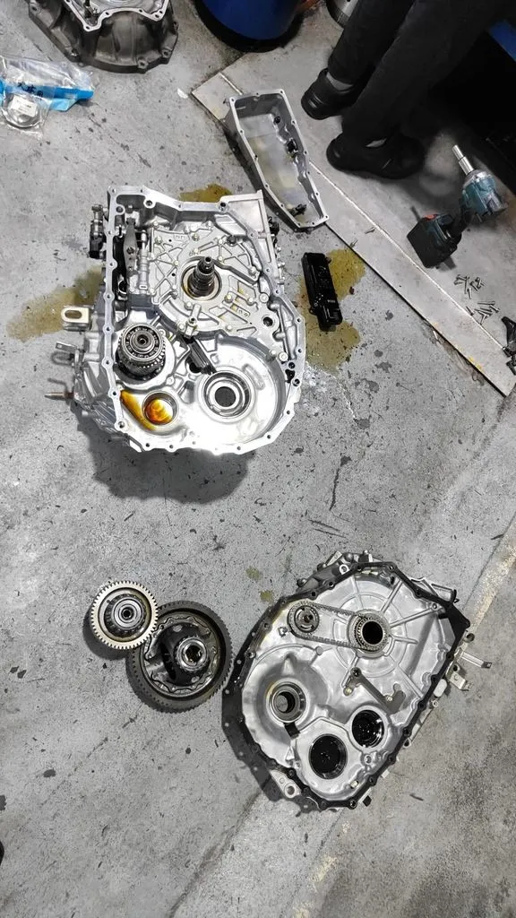 Honda Odyssey automatic gearbox opened up with the casing, gears and clutch drum laid out at our Singapore workshop
