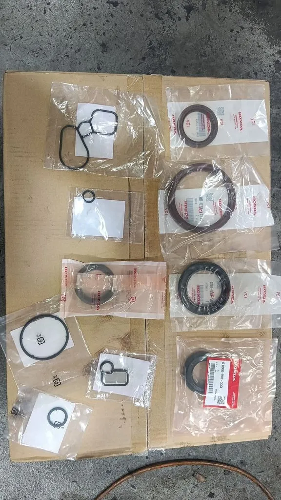 Replacement oil seals and gaskets laid out before fitting on a Honda Odyssey engine at our Singapore workshop