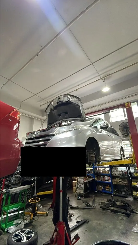 Honda Odyssey raised on a workshop lift for oil seal replacement at our Singapore workshop
