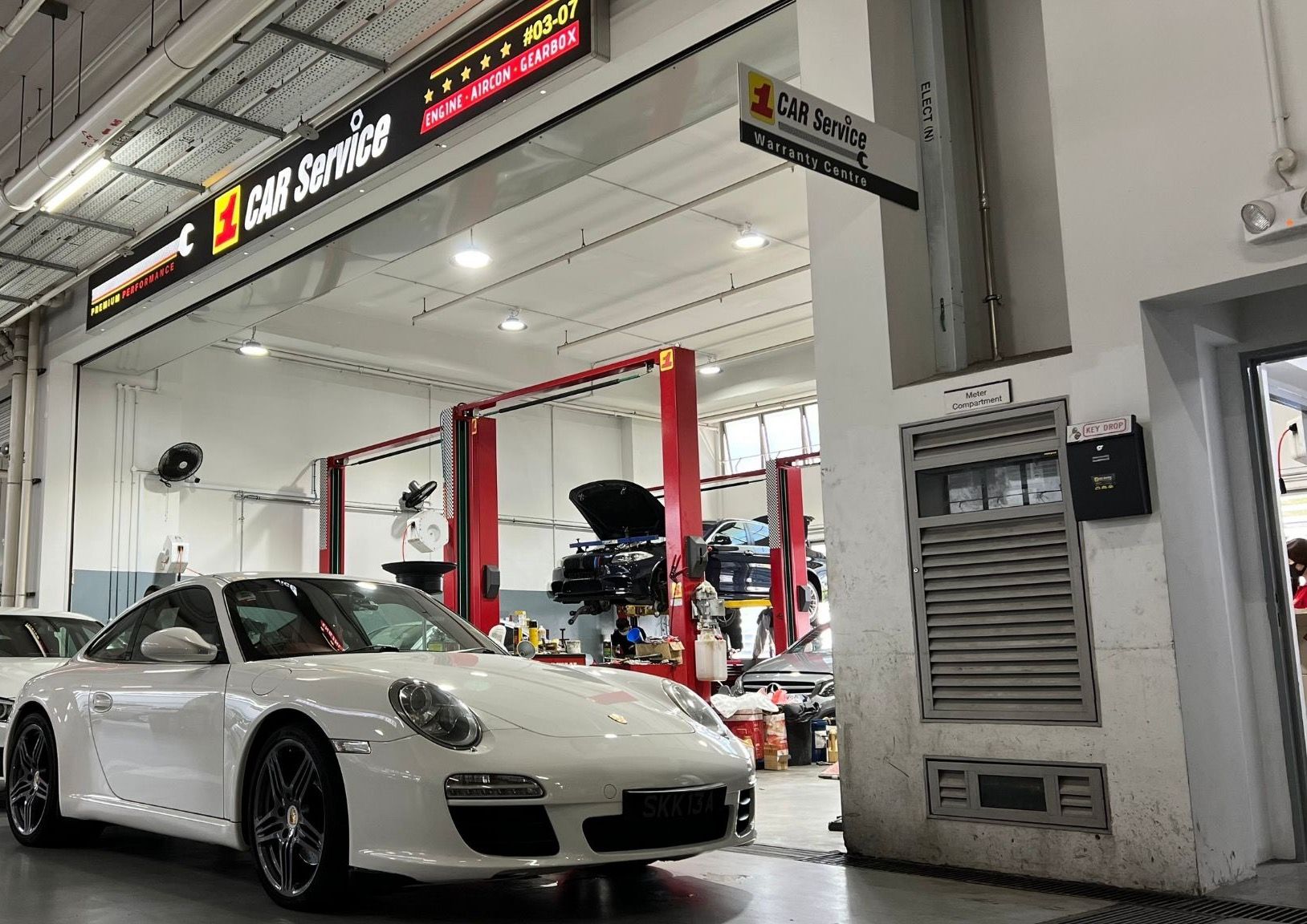 The 1 Car Service workshop at Sin Ming AutoCity, with a Porsche 911 at the service bays