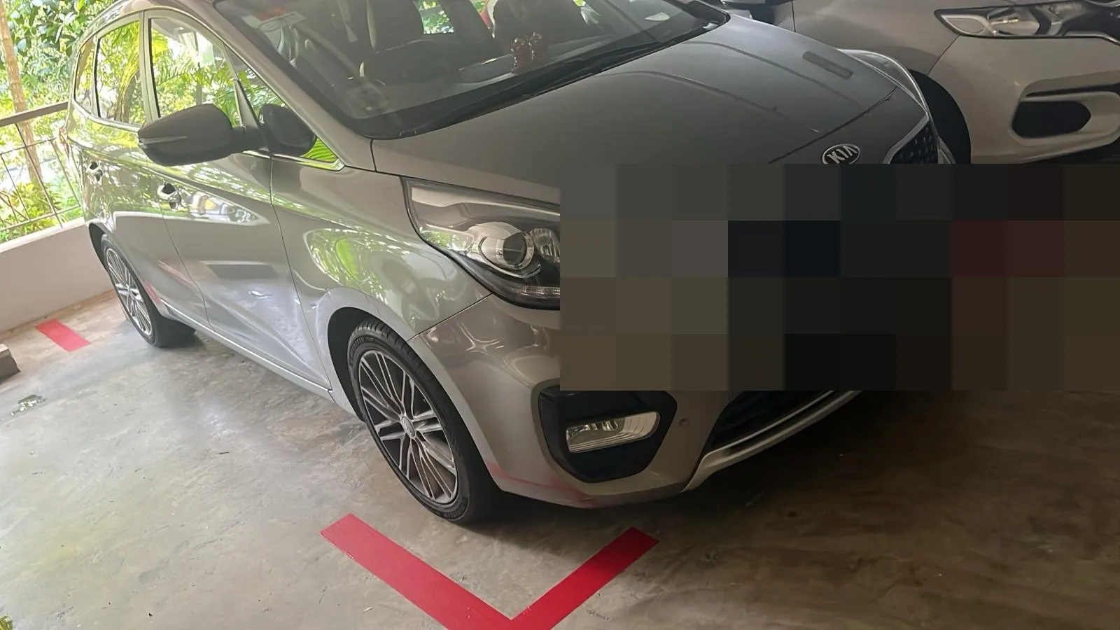 Kia Carens parked in a basement car park, picked up for servicing.