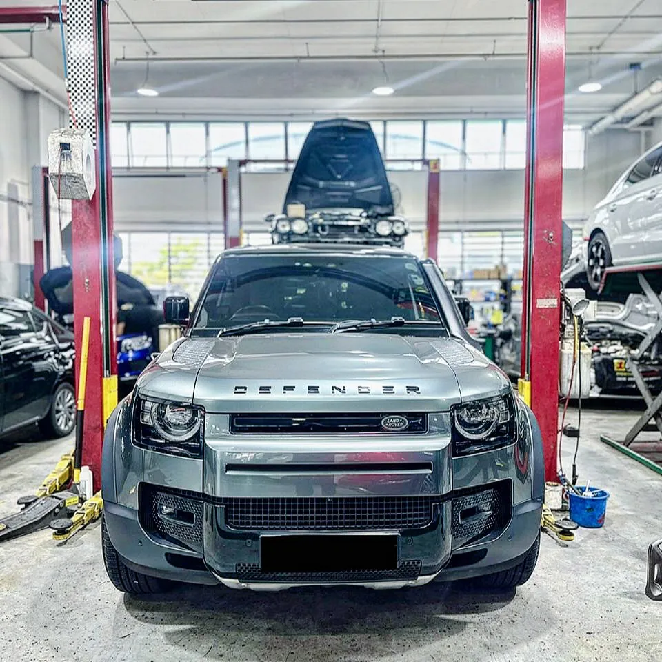 Land Rover Defender up on the lift for servicing at our Singapore workshop