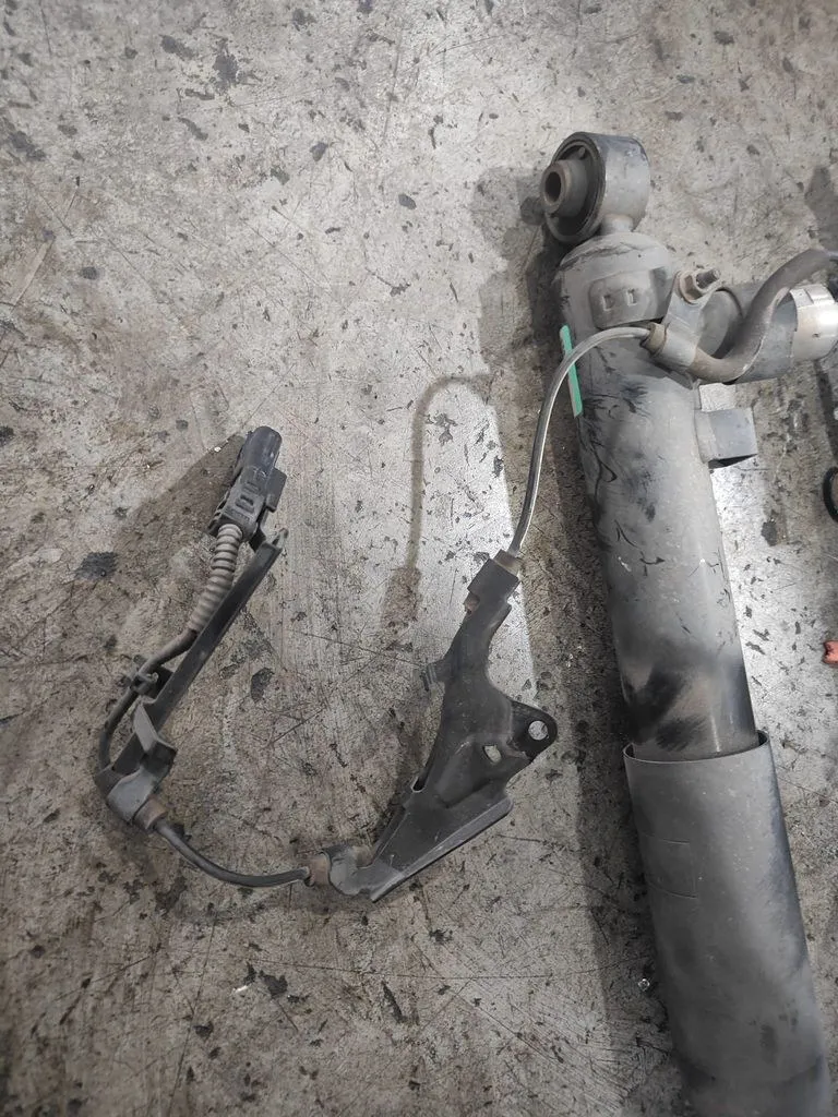 Old Lexus IS F-Sport AVS electric absorber components removed, showing sensor bracket and strut body at 1 Car Service Singapore