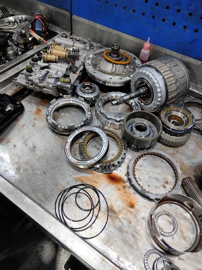 Lexus GS300 automatic gearbox stripped down for an overhaul, internal clutch packs and parts laid out