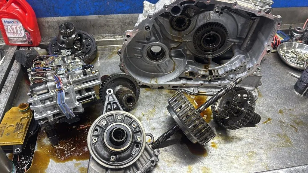 Mazda 3 automatic gearbox dismantled showing gears, casing halves and clutch drum at 1 Car Service workshop Singapore