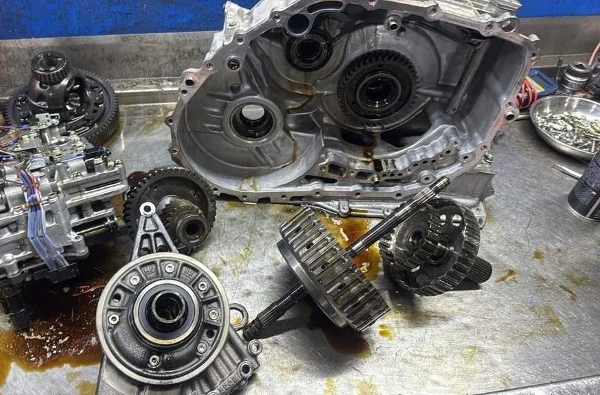 Mazda 3 automatic gearbox dismantled showing gears, casing halves and clutch drum at 1 Car Service workshop Singapore