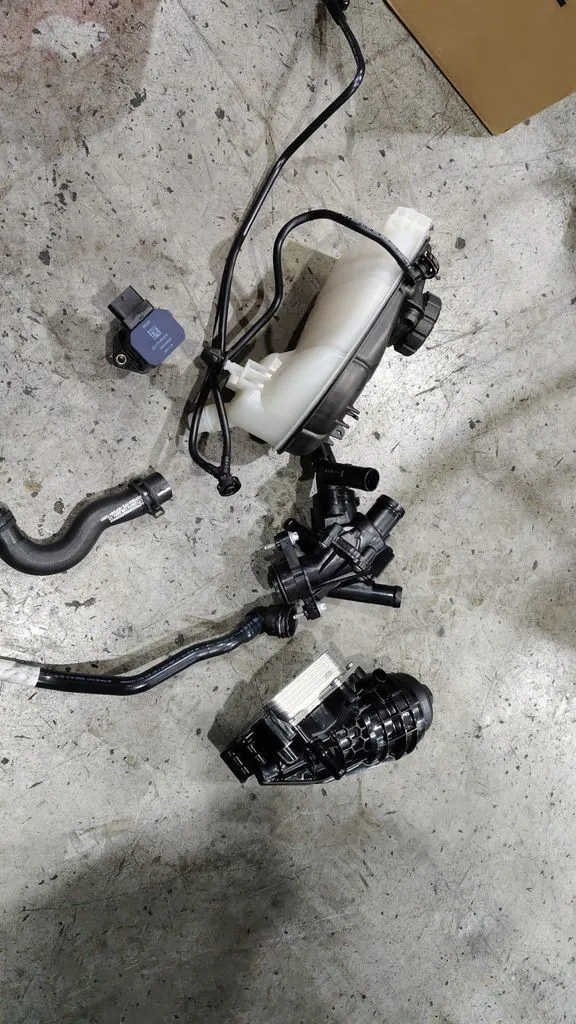Removed coolant expansion tank, hoses and thermostat from a Mercedes-Benz CLA leak repair at our Singapore workshop