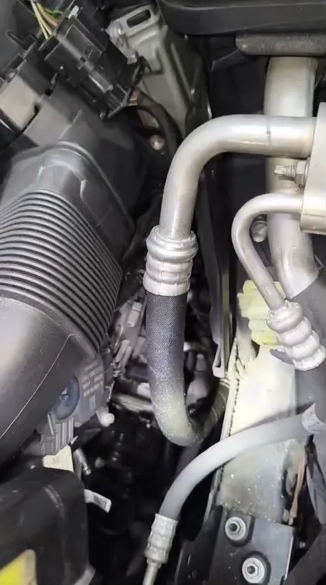 Mercedes C180 engine bay with new aircon pipe installed during aircon hose replacement at Singapore workshop