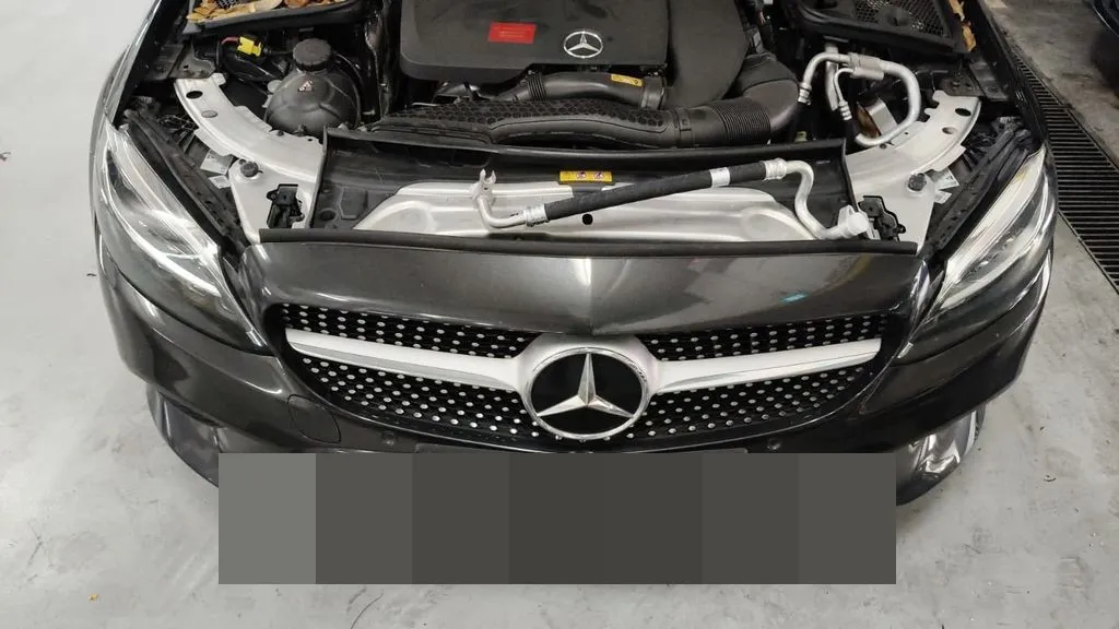 Mercedes C180 in the workshop with bonnet open during aircon pipe replacement, engine bay inspection