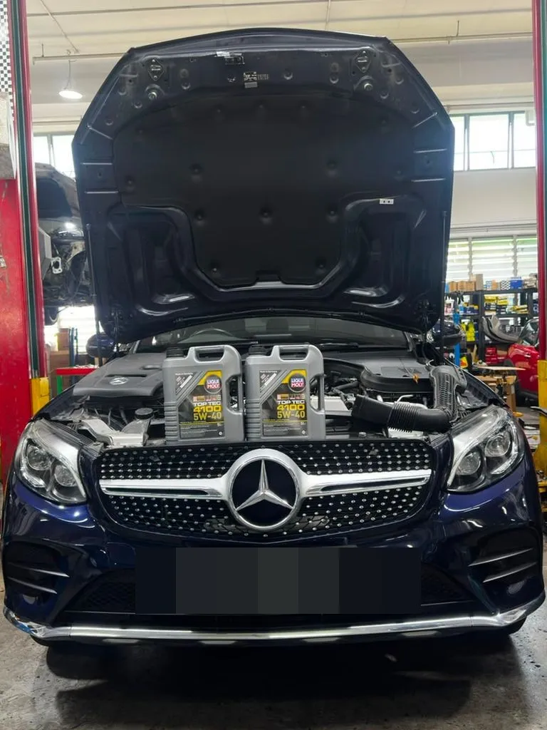 Dark blue Mercedes GLC coupe in the workshop bay at our Singapore workshop during a major service