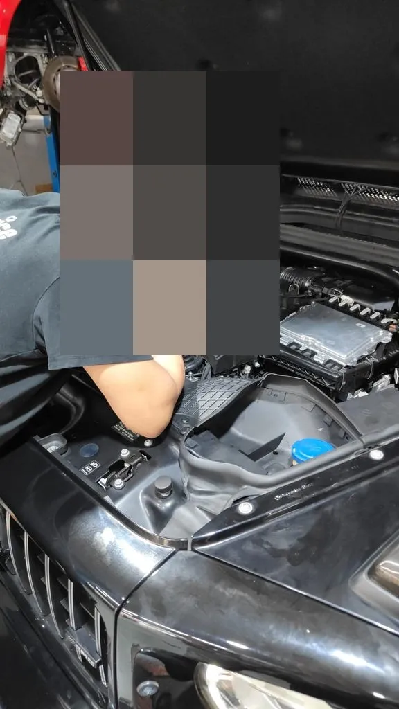 Engine bay of a black Mercedes-Benz open during turbo boost sensor diagnosis at our Singapore workshop