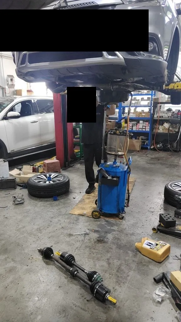 Mitsubishi Outlander on the workshop lift with both new CV driveshafts on the floor at 1 Car Service Singapore