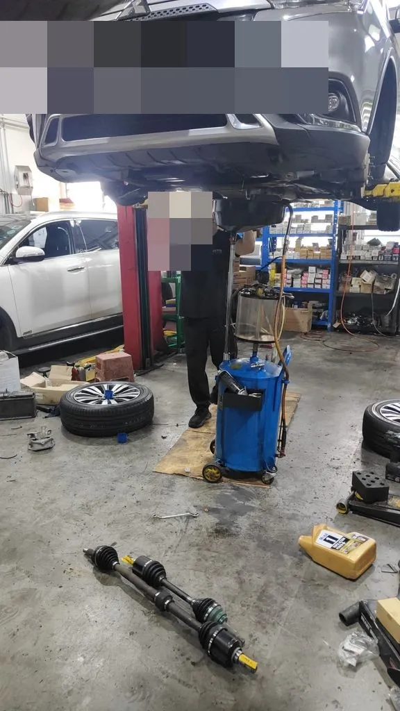 Mitsubishi Outlander on the workshop lift with both new CV driveshafts on the floor at 1 Car Service Singapore
