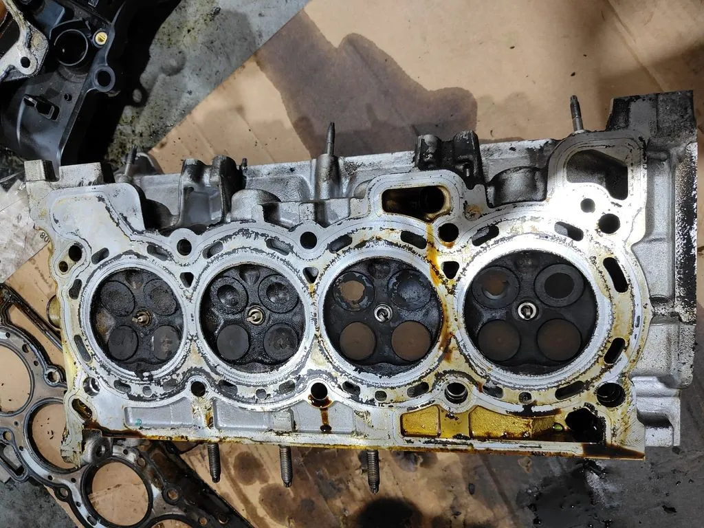 Reconditioned Nissan Qashqai cylinder head with valves exposed for inspection at our Singapore workshop