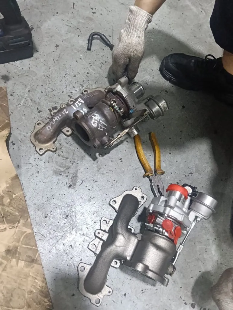 Old failing turbocharger removed from a Nissan Qashqai next to the replacement unit, at our Singapore workshop