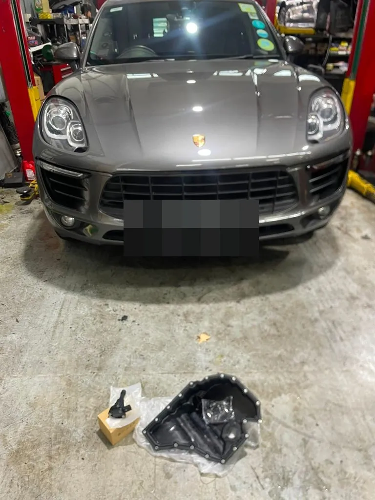 Porsche Macan with the oil sump removed and a new oil level sensor on the floor, at our Singapore workshop