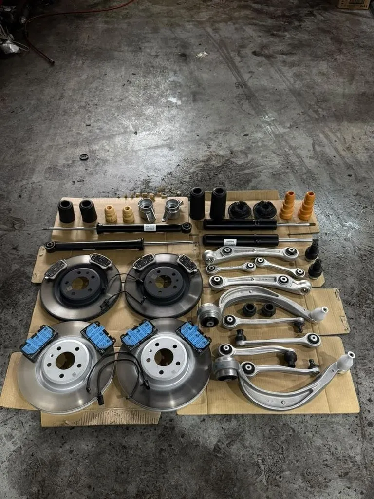 Porsche Macan suspension and brake parts laid out before installation at 1 Car Service Singapore workshop
