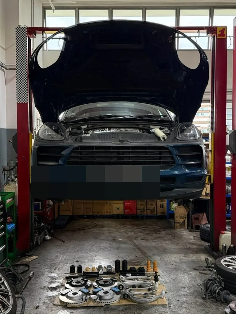 Porsche Macan raised on the workshop lift for a full suspension inspection